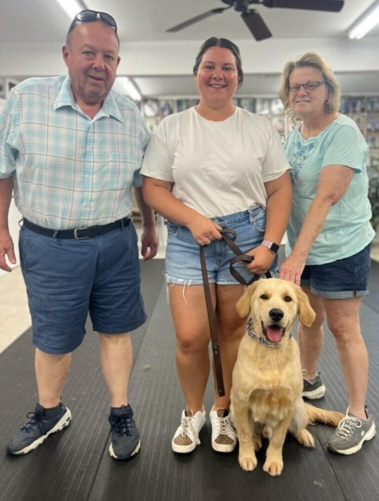a group of people standing next to a dog