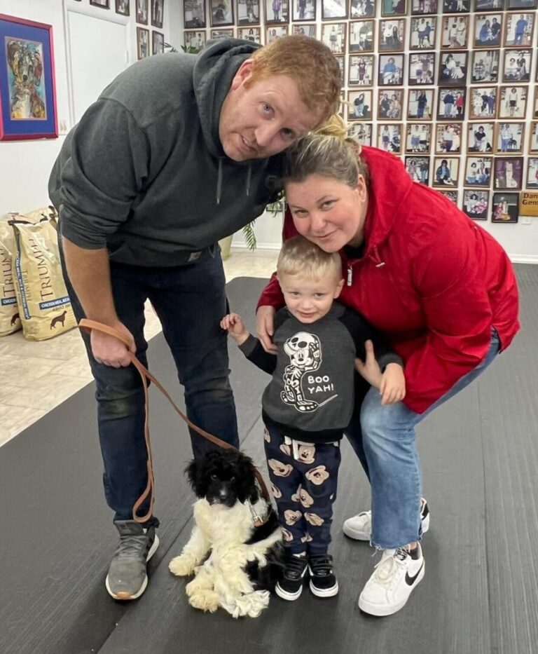 a woman and two children with a dog