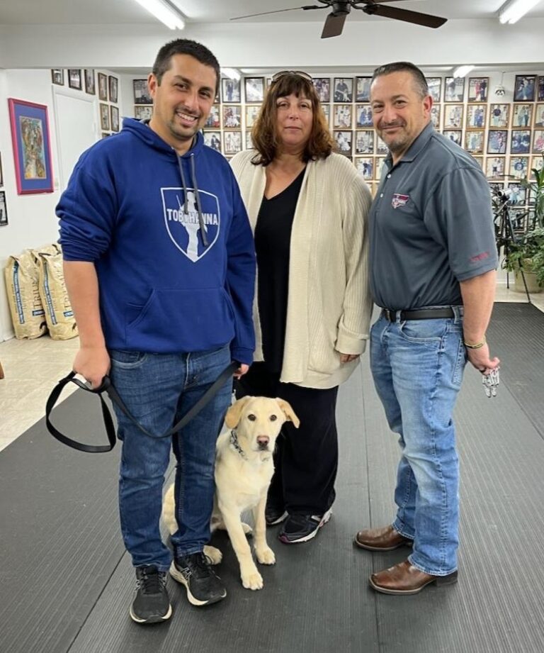 a group of people standing next to a dog