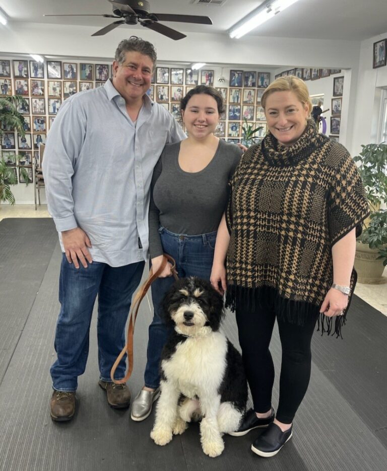a group of people standing next to a dog