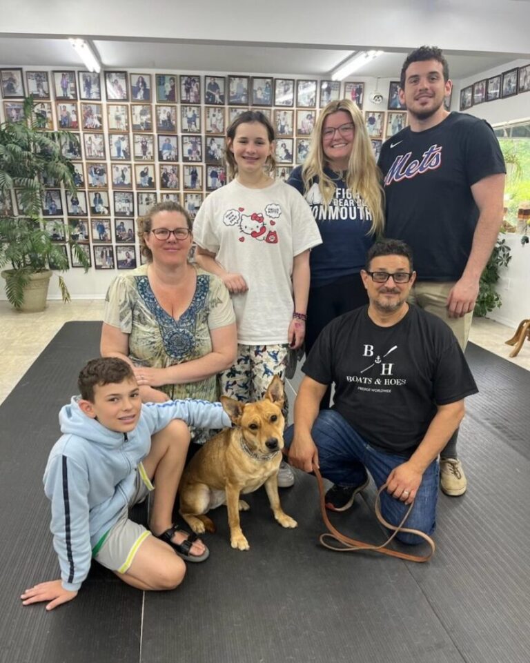 a group of people posing for a picture with a dog