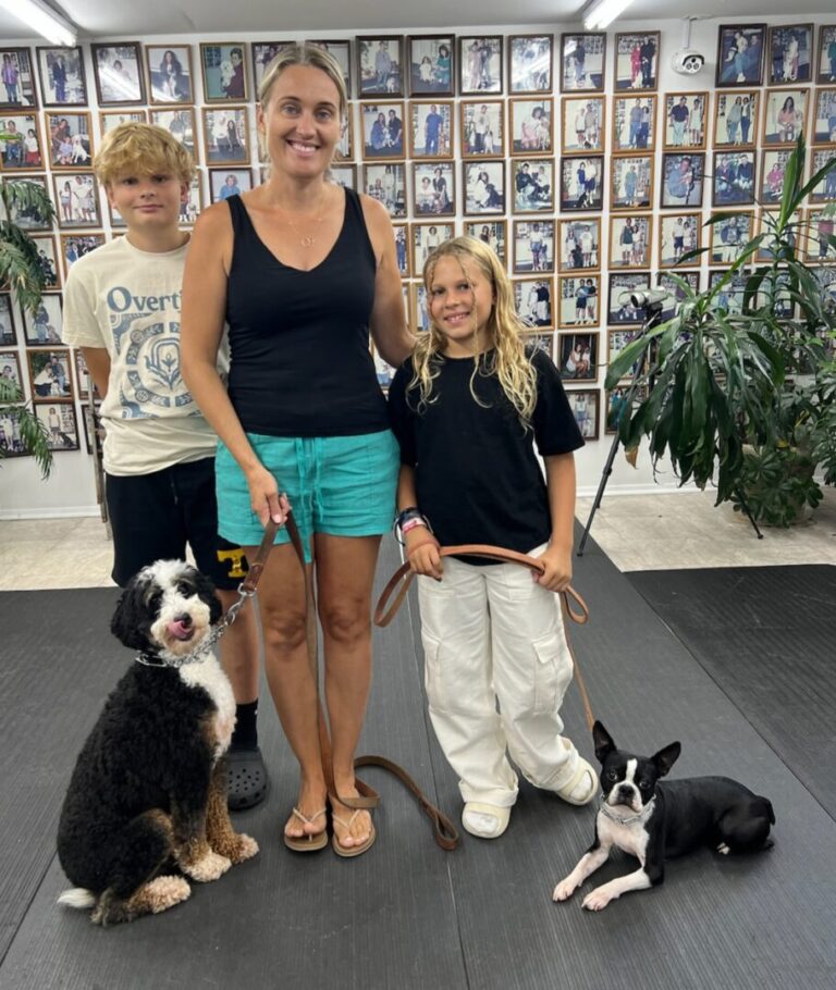 a woman and two children with two dogs