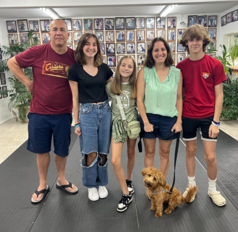 a family posing for a picture with a dog