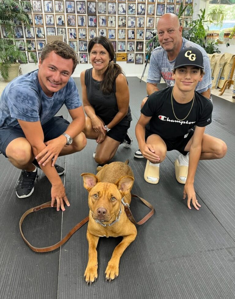 a group of people posing for a picture with a dog