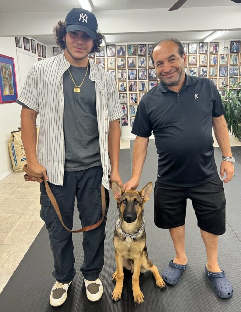a man standing next to a dog on a leash