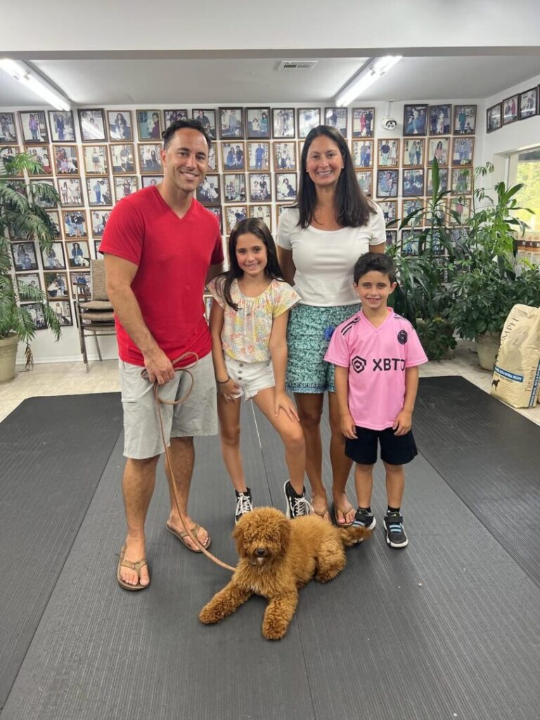 a family posing for a picture with a dog