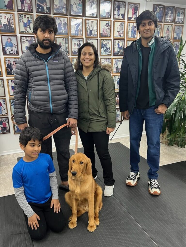 a group of people standing next to a dog