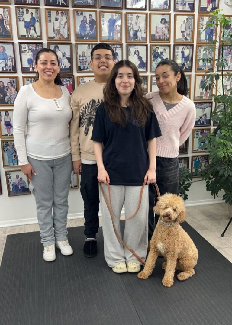 a group of people standing next to a dog