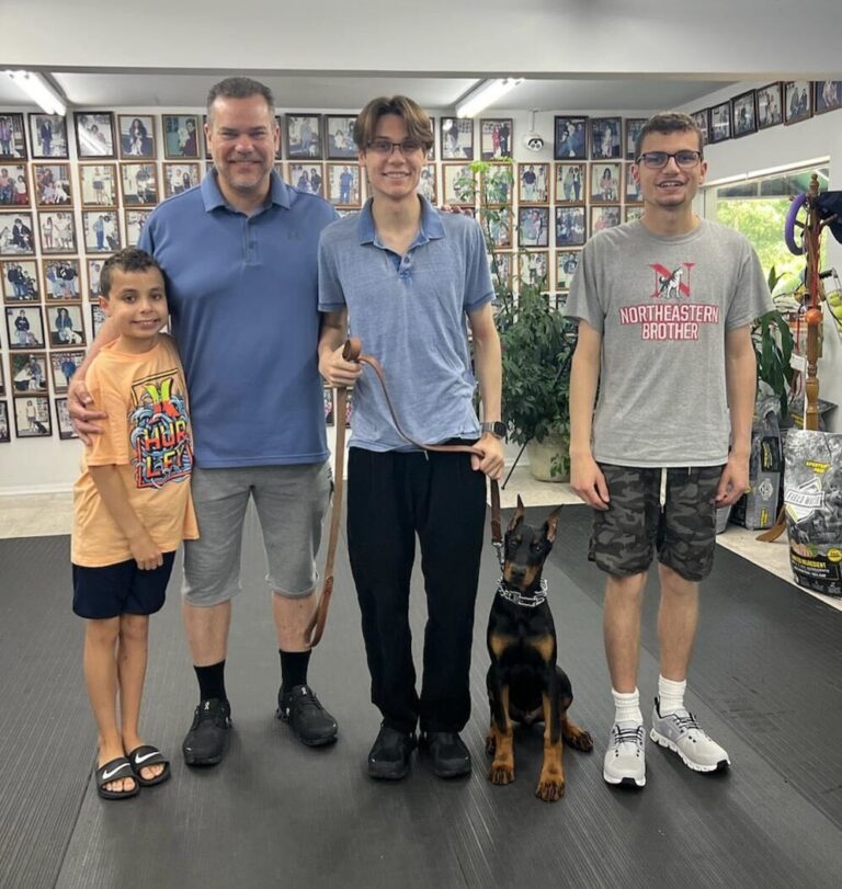 a family poses for a picture with their dog