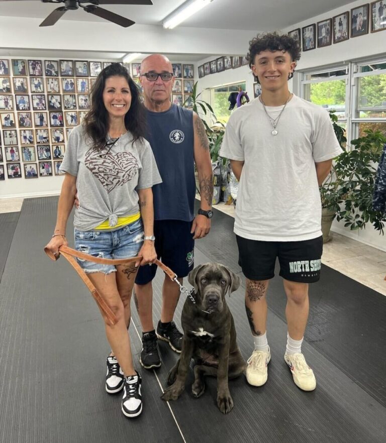 a group of people standing next to a dog