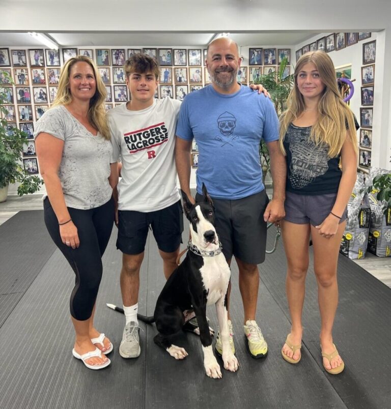 a group of people posing for a picture with a dog