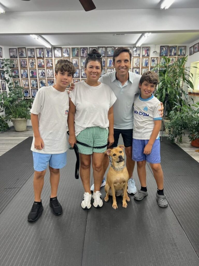 a group of people standing next to a dog