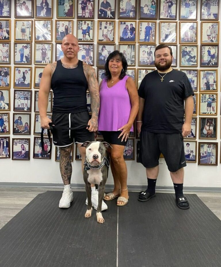 a group of people standing next to a dog