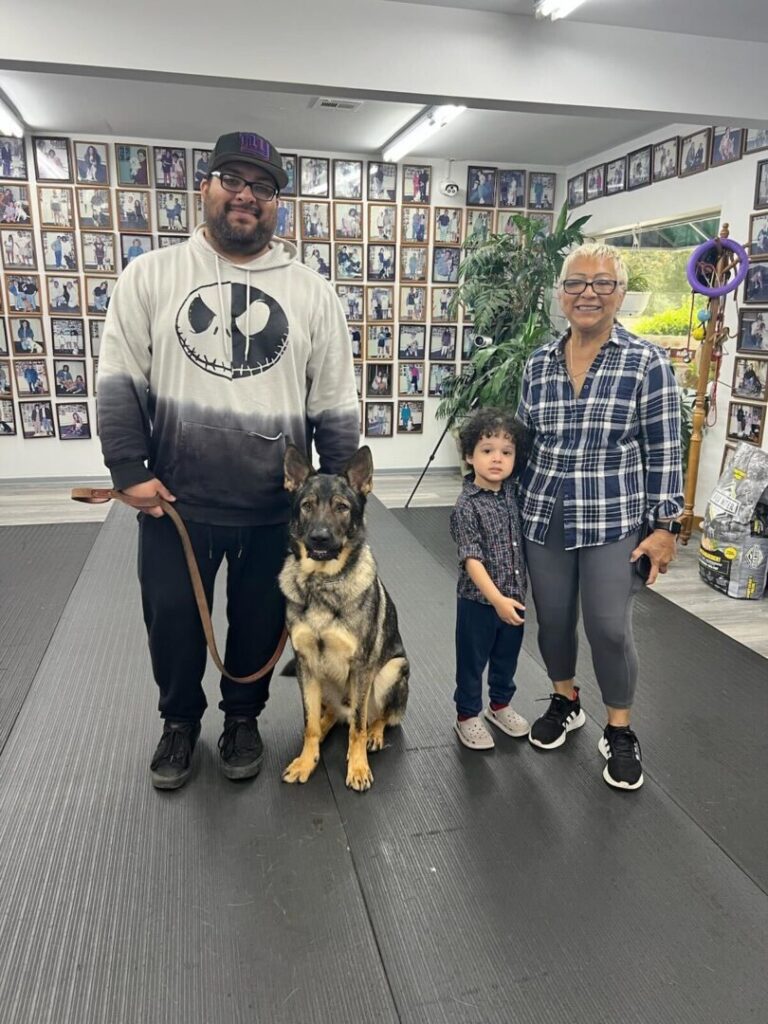 a man and two children and a dog