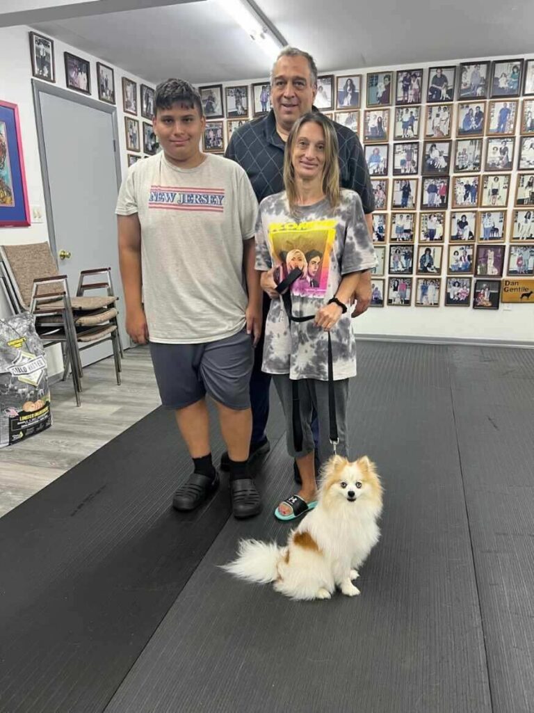 a group of people standing next to a small dog