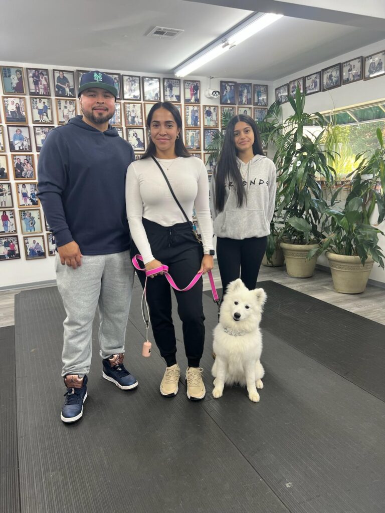 a group of people standing with a dog