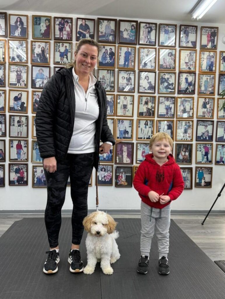 Mercer County Dog Trainer, a woman standing next to a boy and a dog