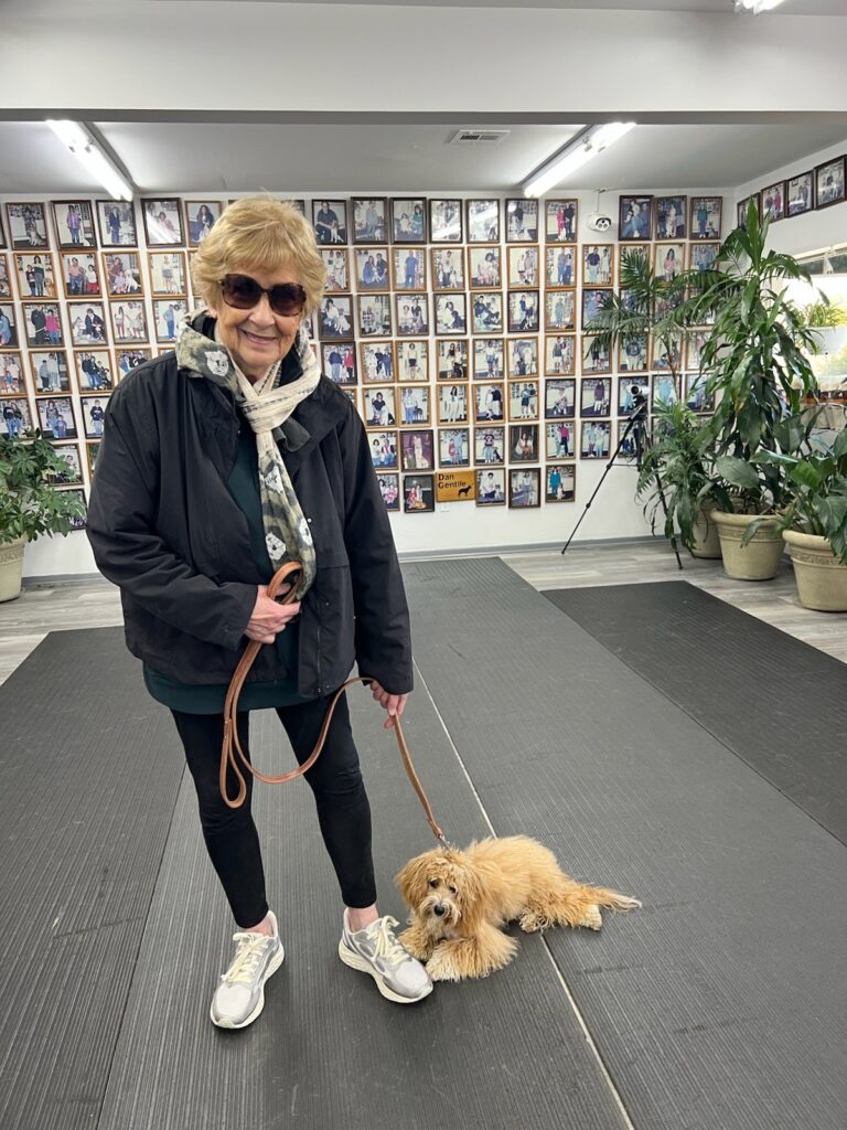 a woman holding a dog on a leash