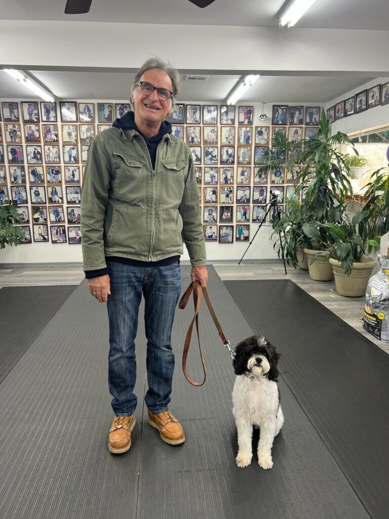 a man standing with a dog on a leash
